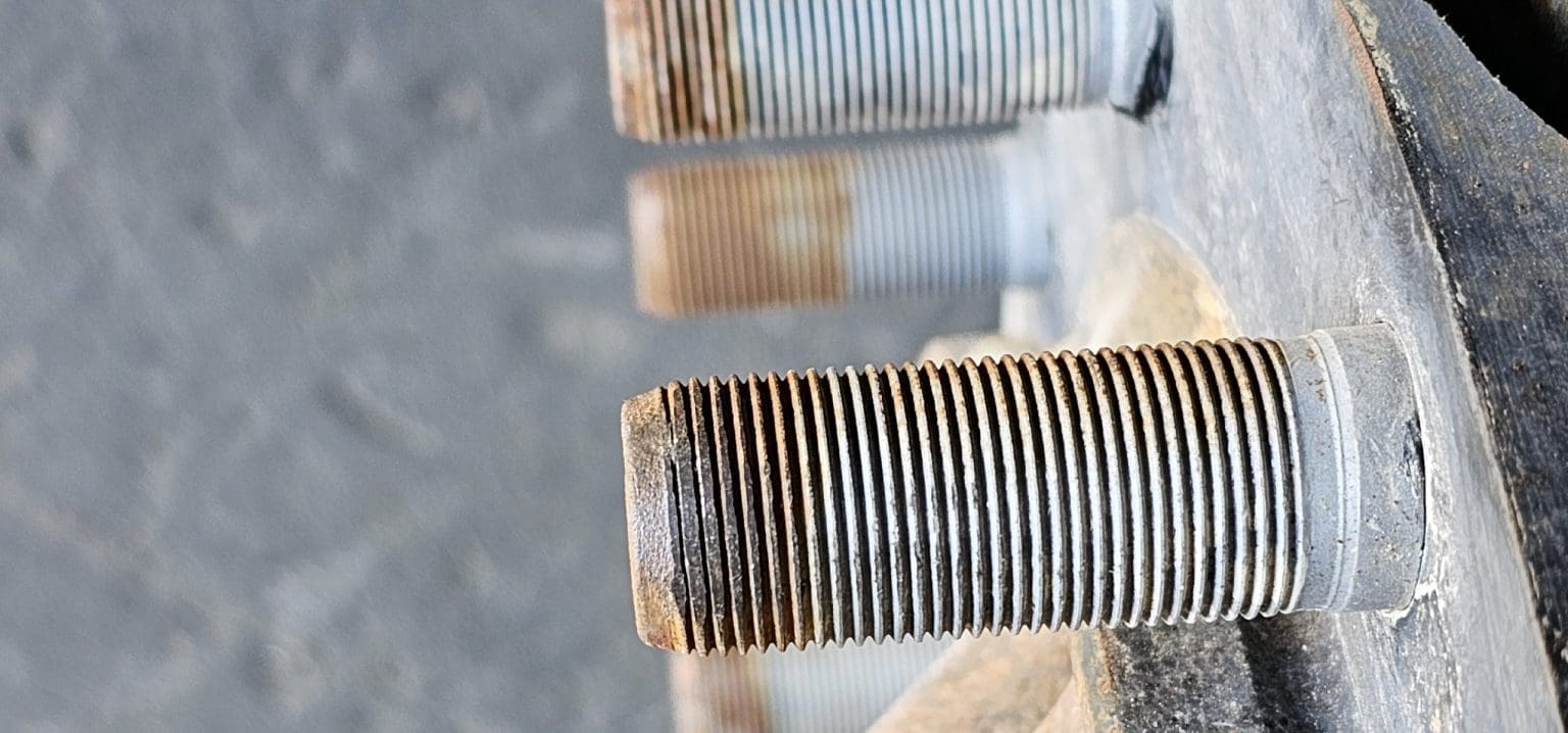 Close-up of a damaged commercial vehicle wheel bolt thread