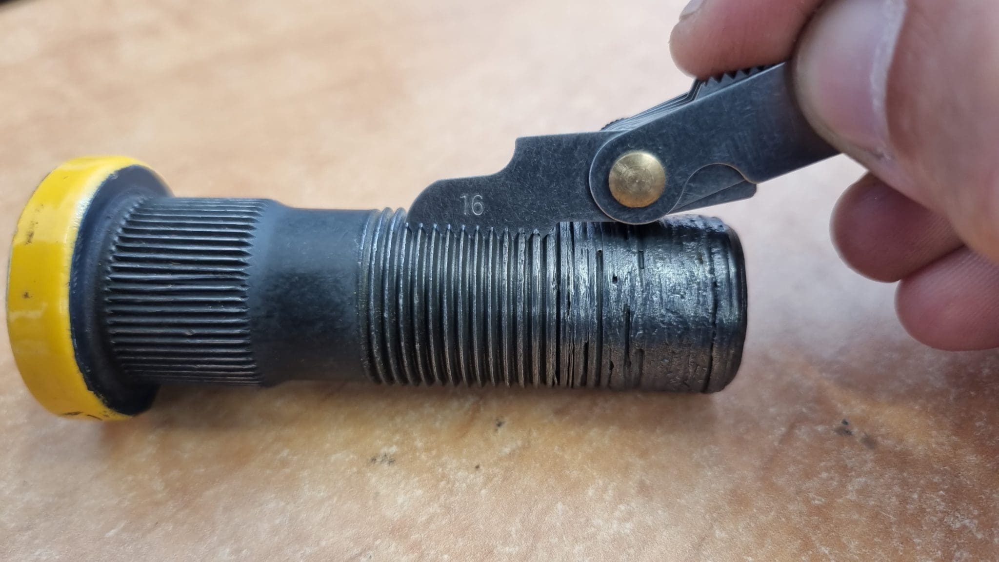 X-Nut XL tool clamped on a wheel bolt to restore the thread
